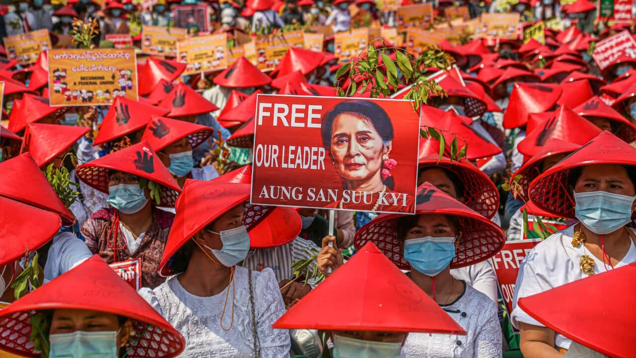 A protesting teacher hold up a poster reading Free our leader Aung San Suu Kyi during the military coup demonstrations.