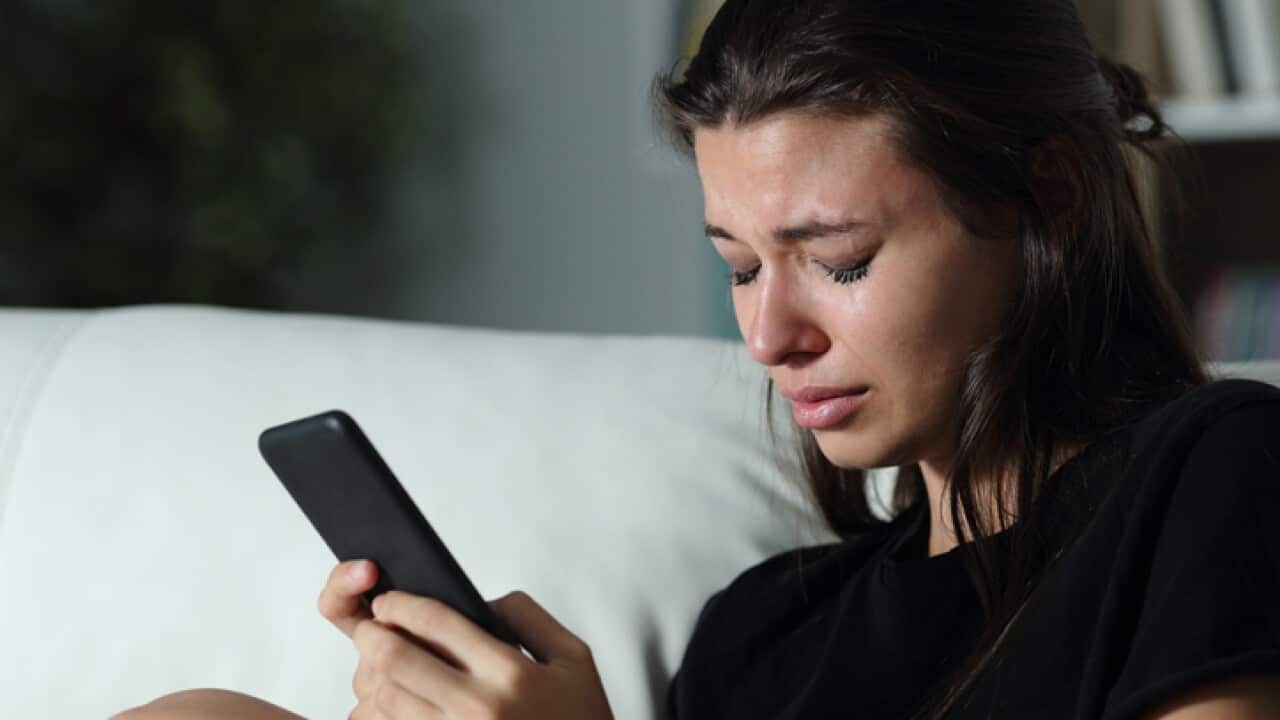 Sad teen crying after read phone message