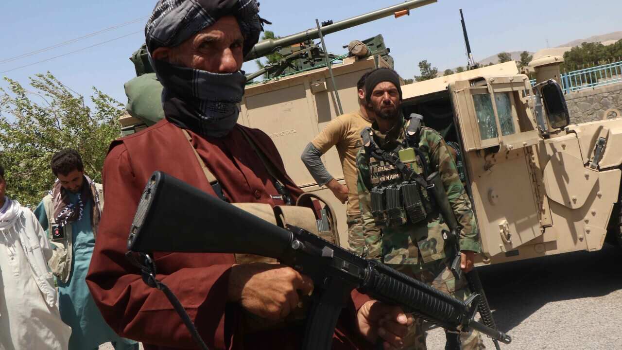 Afghan security officials and private militia patrol after they took back control of parts of Herat city after a battle with Taliban militants on 5 August.