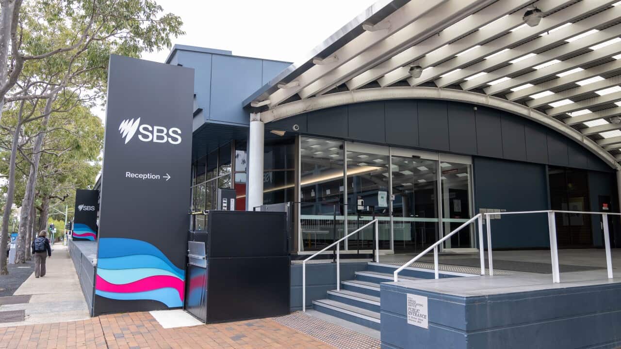 The outside of an office building with a staircase and sign that says 'SBS'.