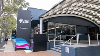 The outside of an office building with a staircase and sign that says 'SBS'.