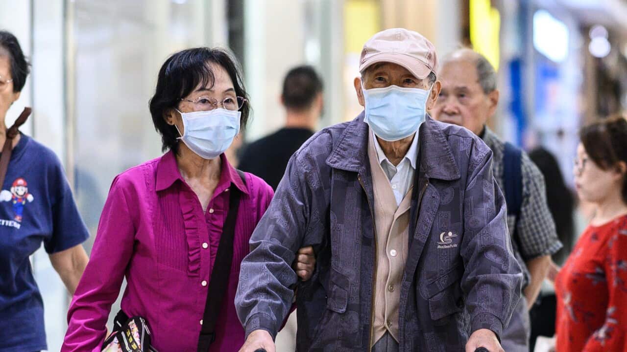 A couple wearing face masks in Sydney