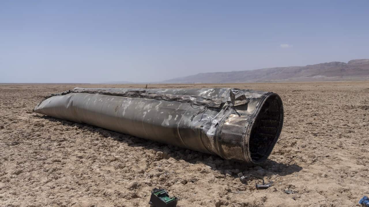 Parts of the intercepted ballistic missile lie in a desert.