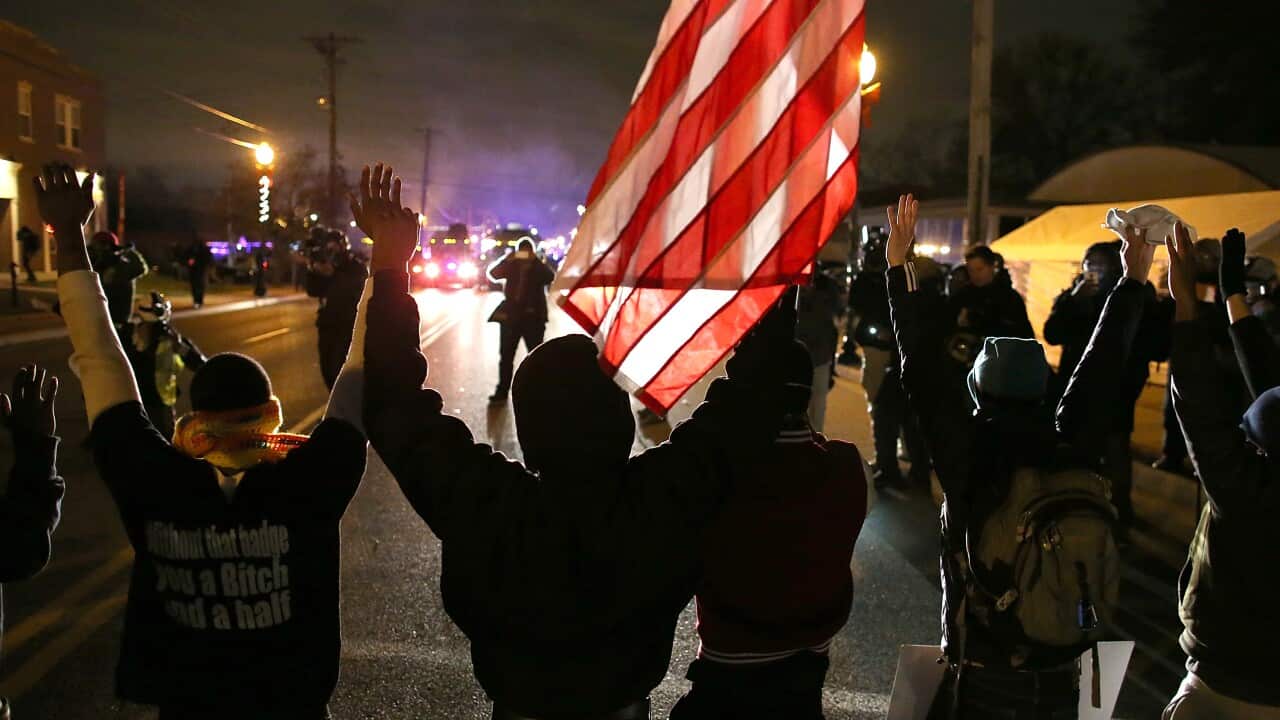 Protestors stand with their hands up during a demonstration on Nov 24, 2014 in Ferguson, Missouri. A St. Louis County grand jury has decided to not indict officer Darren Wilson in the shooting of Michael Brown in August. (Justin Sullivan/Getty)