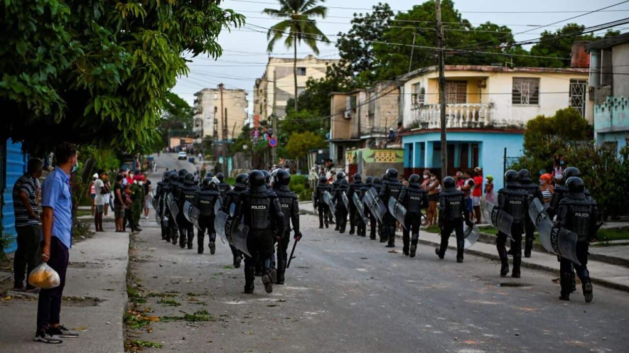Riot police walk the streets after a demonstration against the government of President Miguel Diaz-Canel in Havana on 12 July, 2021.