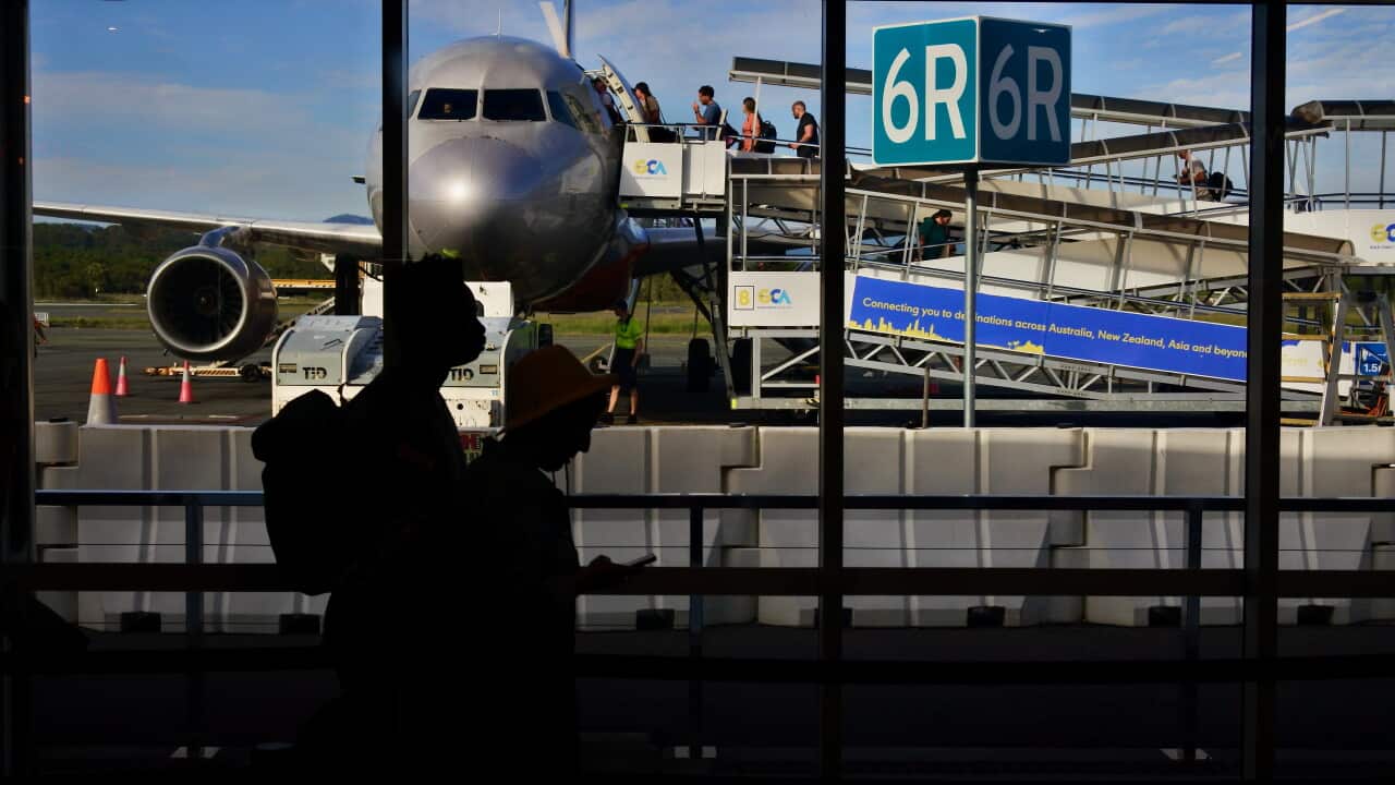 Passengers boarding a plane at an airport.