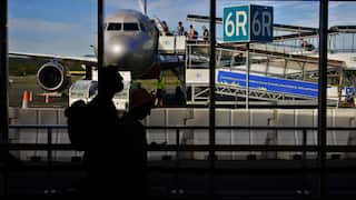 Passengers boarding a plane at an airport.