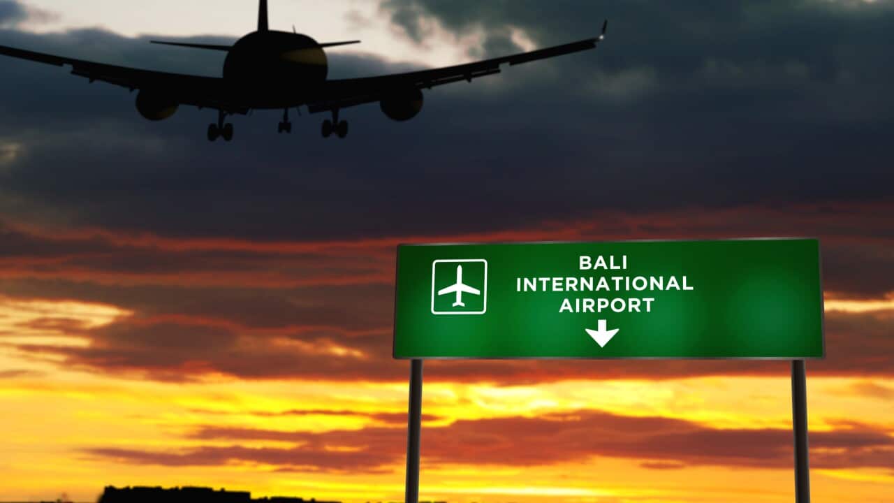 Plane landing in Bali Indonesia airport with signboard