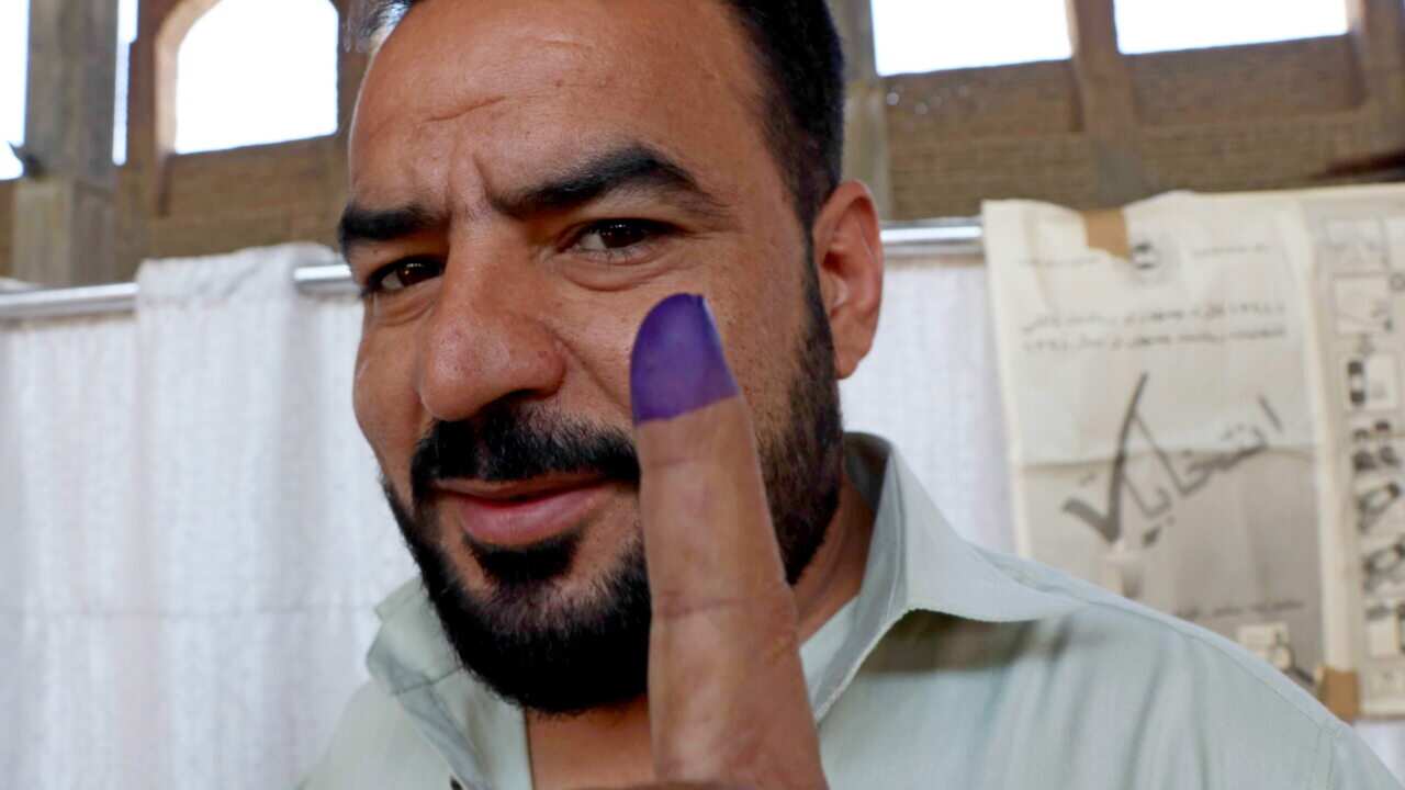 An Afghan man shows his ink-marked finger after casting his ballot during the Presidential elections.
