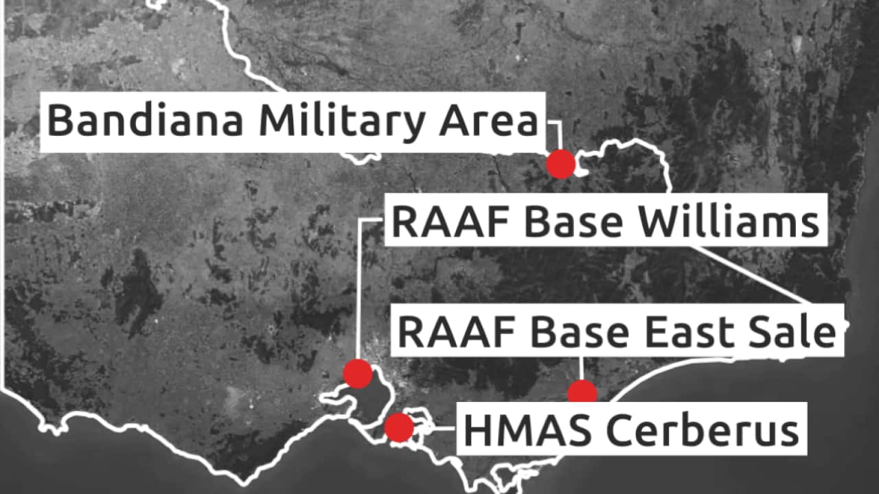 A grayscale map of Victoria showing four Defence-linked PFAS contamination sites marked with red dots. The sites labelled are Bandiana Military Area in the state’s north-east, RAAF Base Williams near Melbourne, RAAF Base East Sale in Gippsland, and HMAS Cerberus on the Mornington Peninsula. The graphic includes SBS branding and cites the Department of Defence as the source.