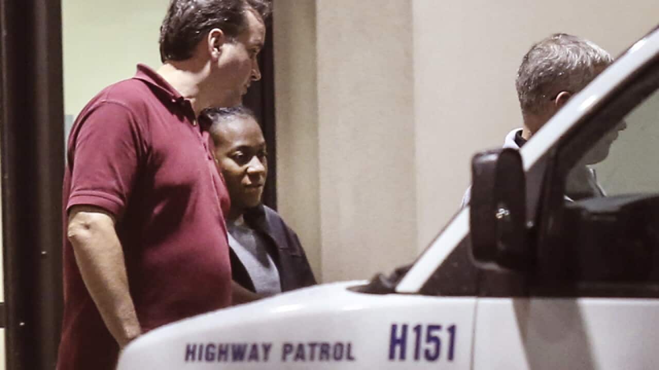 Abduction victim Carlesha Freeland-Gaither is escorted from hospital