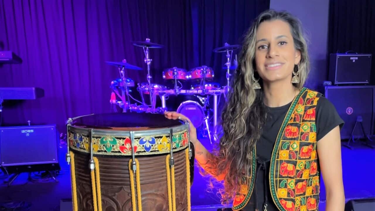 priya standing with drum.jpg