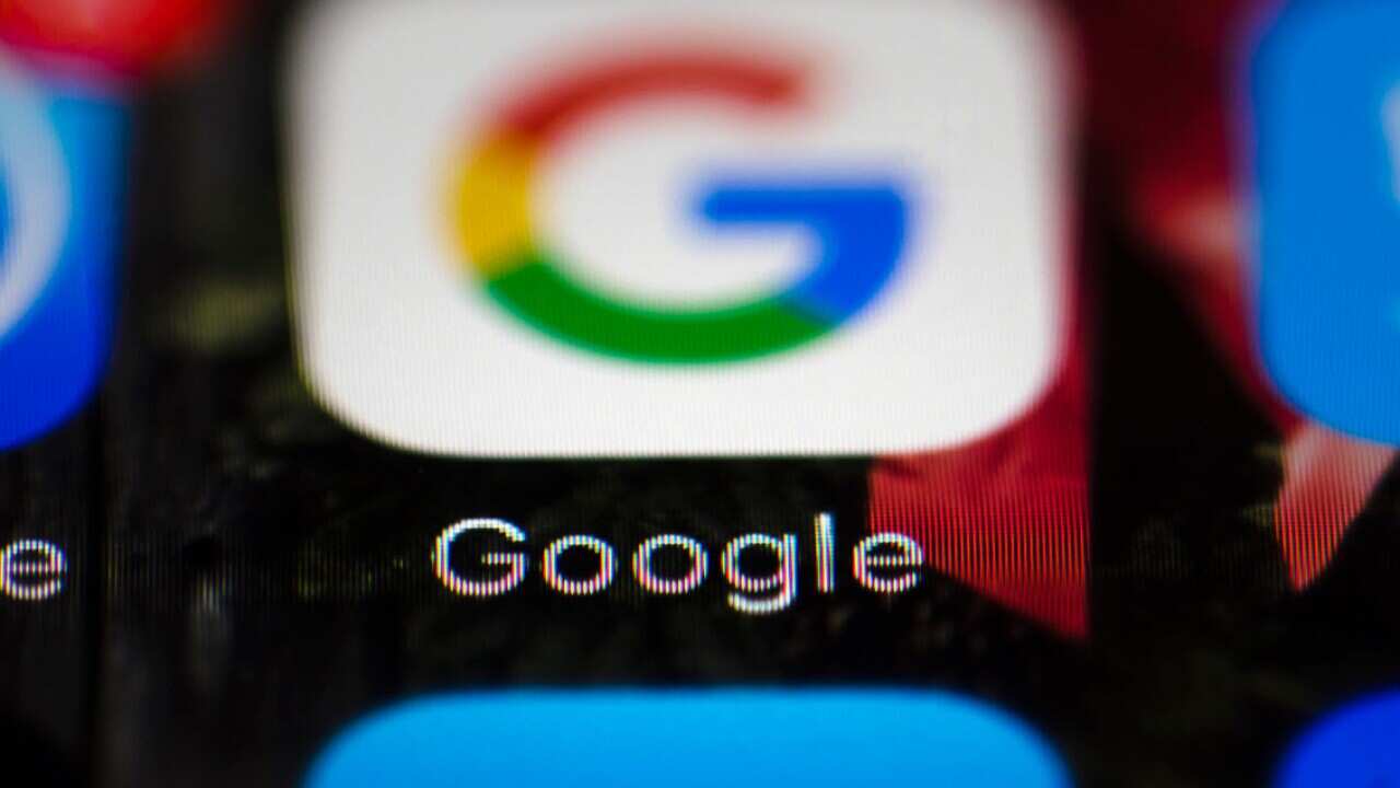 A file photo shows a Google icon on a mobile phone.