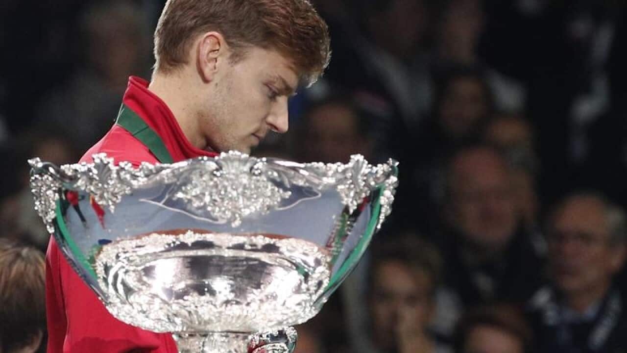 Belgium's David Goffin walks past the cup after France win Davis Cup.