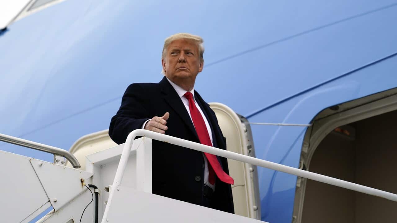 President Donald Trump gestures as he boards Air Force One upon arrival at Valley International Airport, Tuesday, Jan. 12, 2021, in Harlingen, Texas, after visiting a section of the border wall with Mexico in Alamo, Texas. (AP Photo/Alex Brandon)