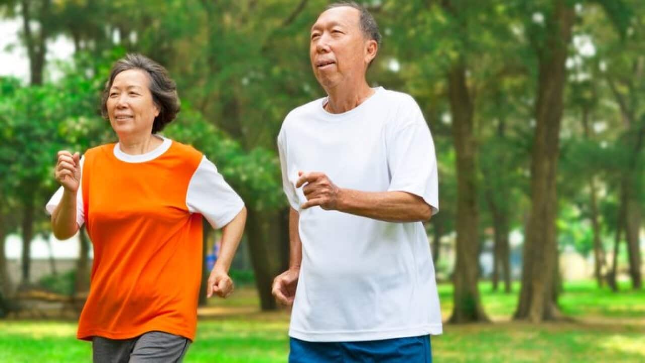 happy senior couple running together