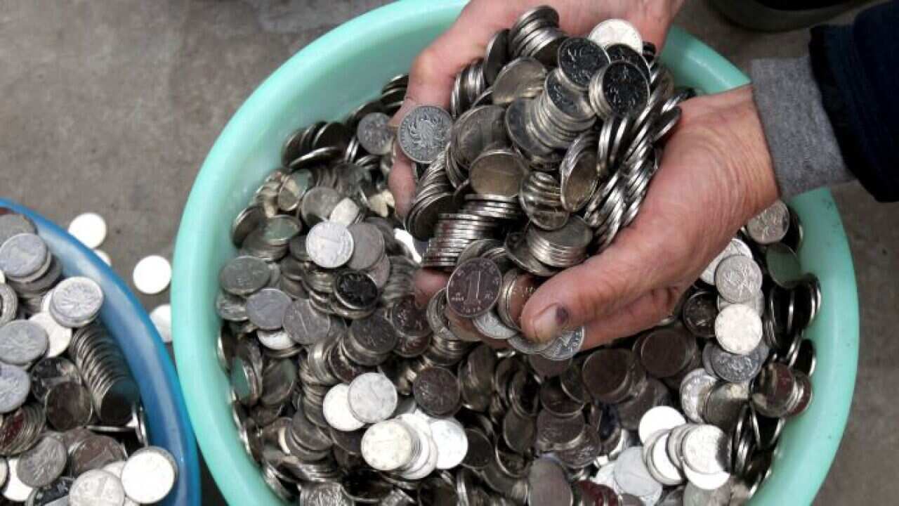A handful coins from a bowl