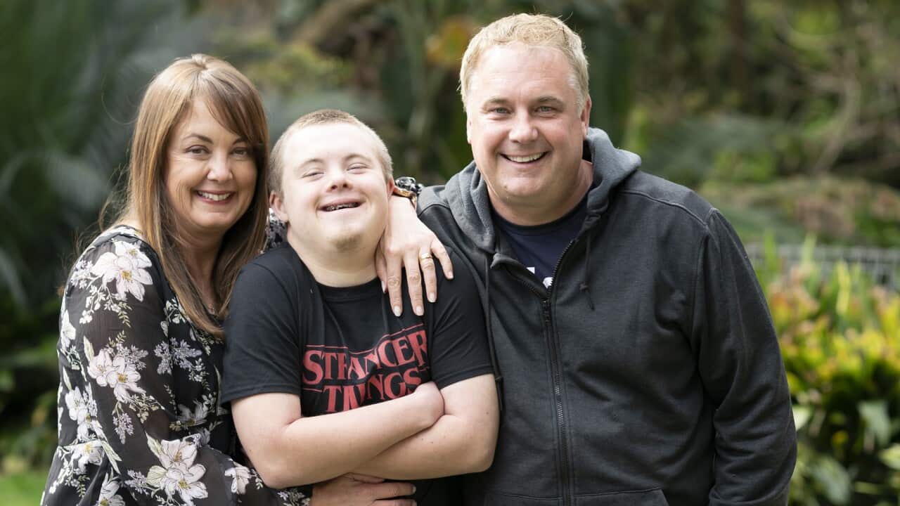 Mum Anita cuddles son Ciaran with Dad Jason in garden