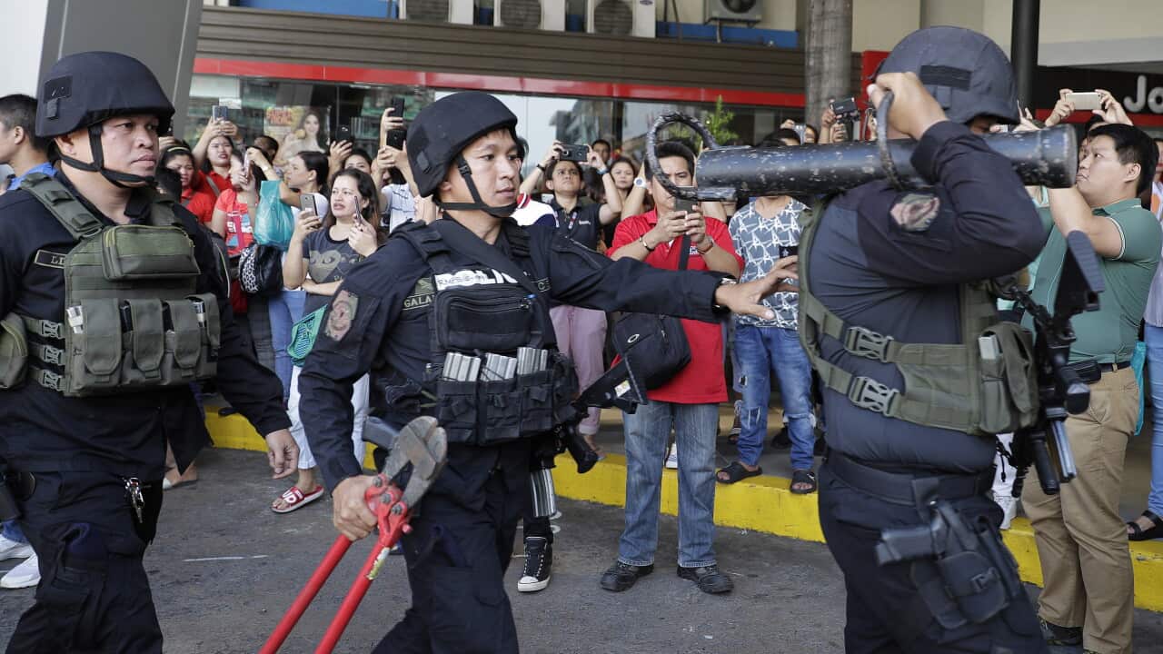 Police prepare to enter the mall in San Juan.