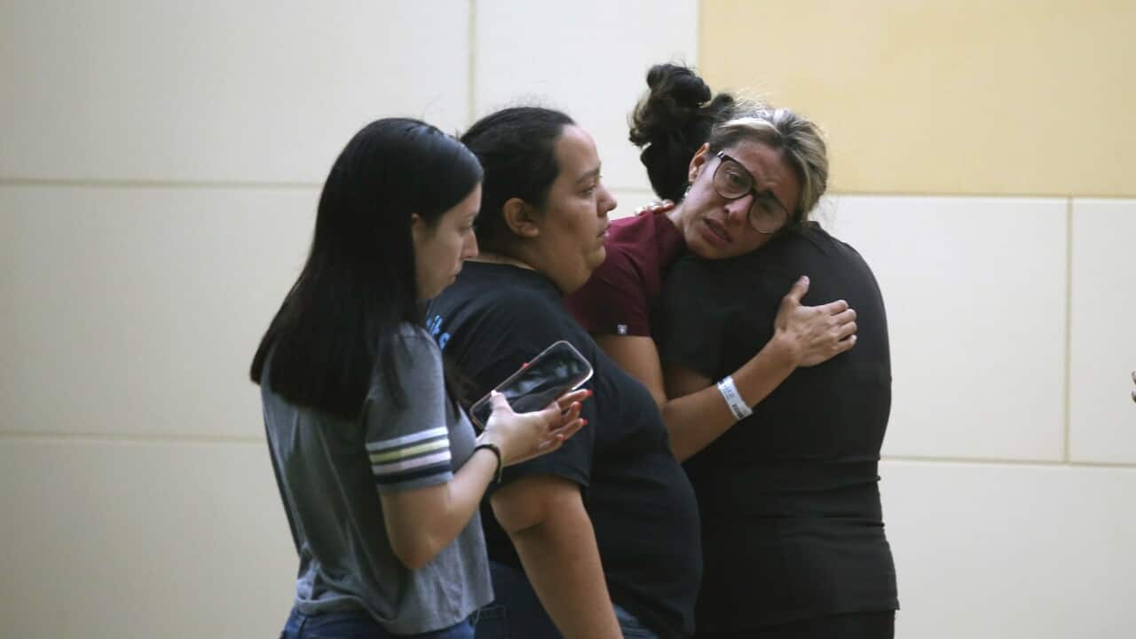 People react outside the Civic Center following a deadly school shooting at Robb Elementary School in Uvalde, Texas Tuesday, May 24, 2022. (AP Photo/Dario Lopez-Mills)