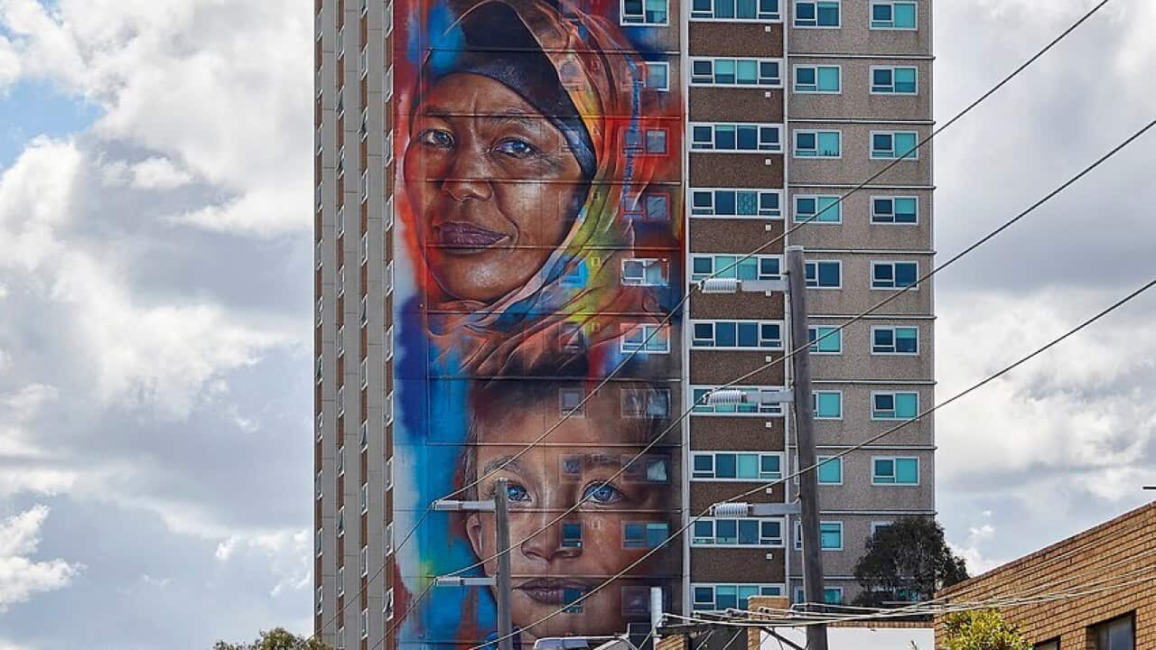 Four faces will eventually feature on the side of a housing commission building in Melbourne.