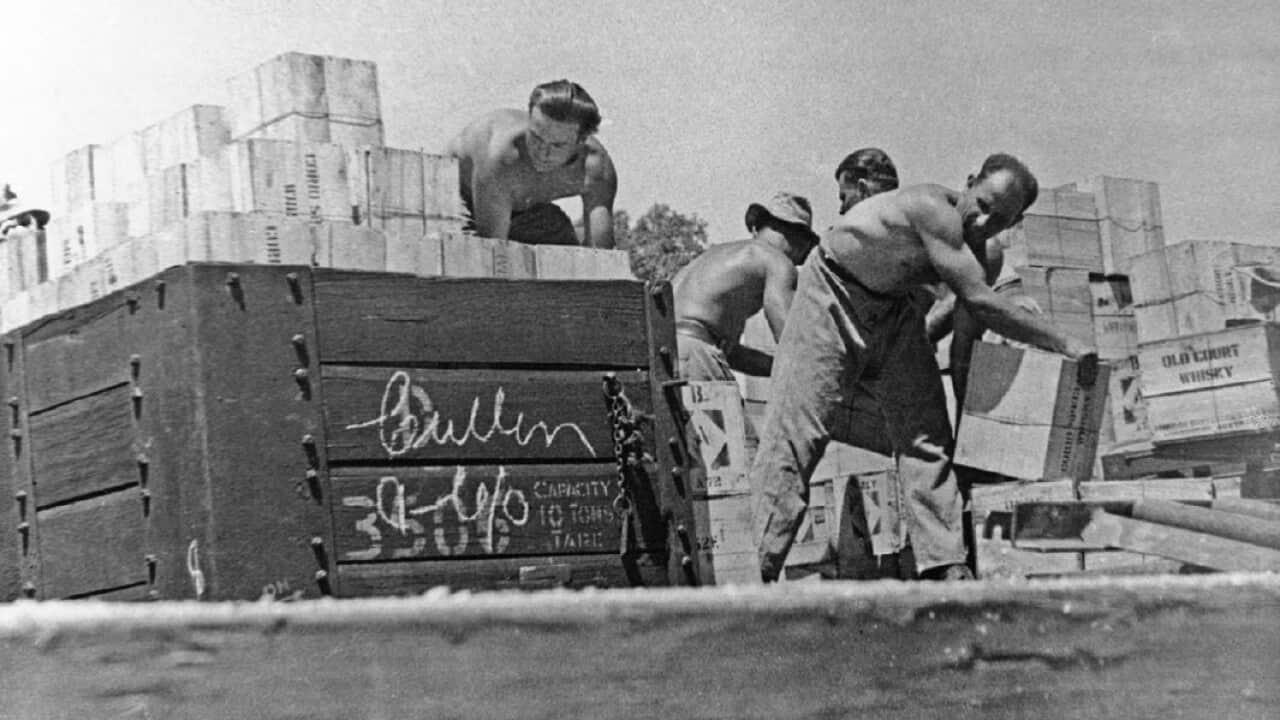 Members of 6th Employment Company unloading railway trucks
