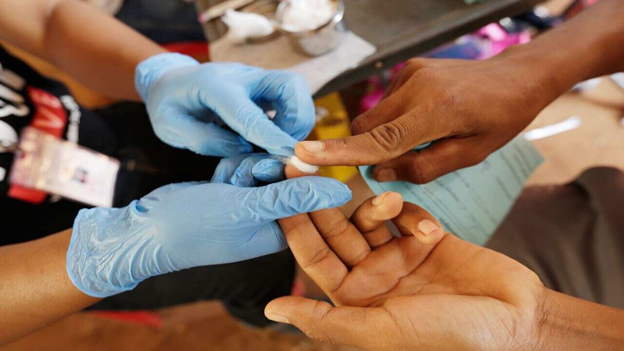 Cambodian health authorities make a blood test on the villagers as they concern about spreading HIV.