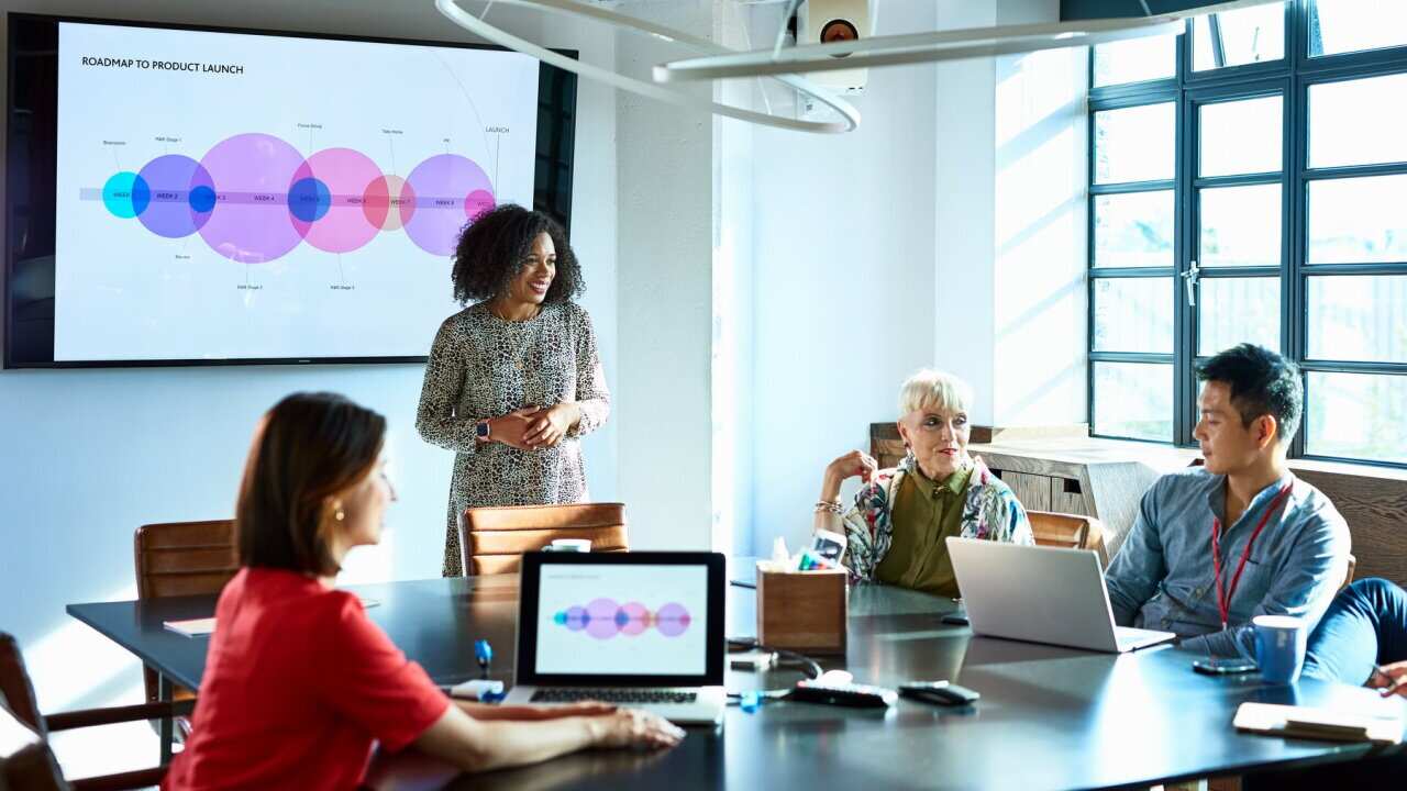 Attractive businesswoman heads strategy meeting in board room