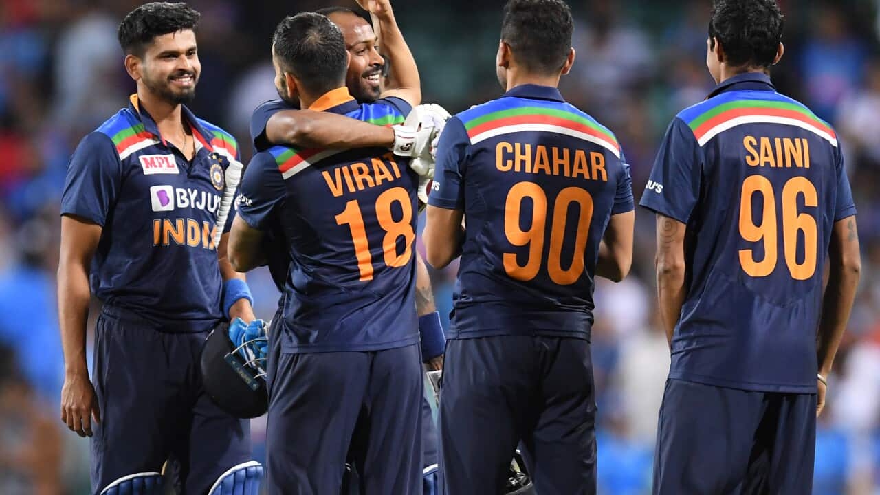 Virat Kohli of India congratulates batsmen Shreyas Iyer ands Hardik Pandya following their win over Australia during the second T20