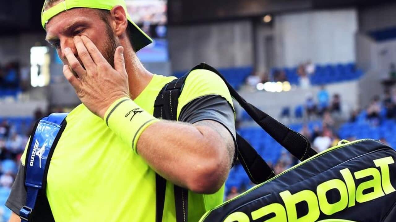 Sam Groth wipes a tear after his final match as a tennis professional