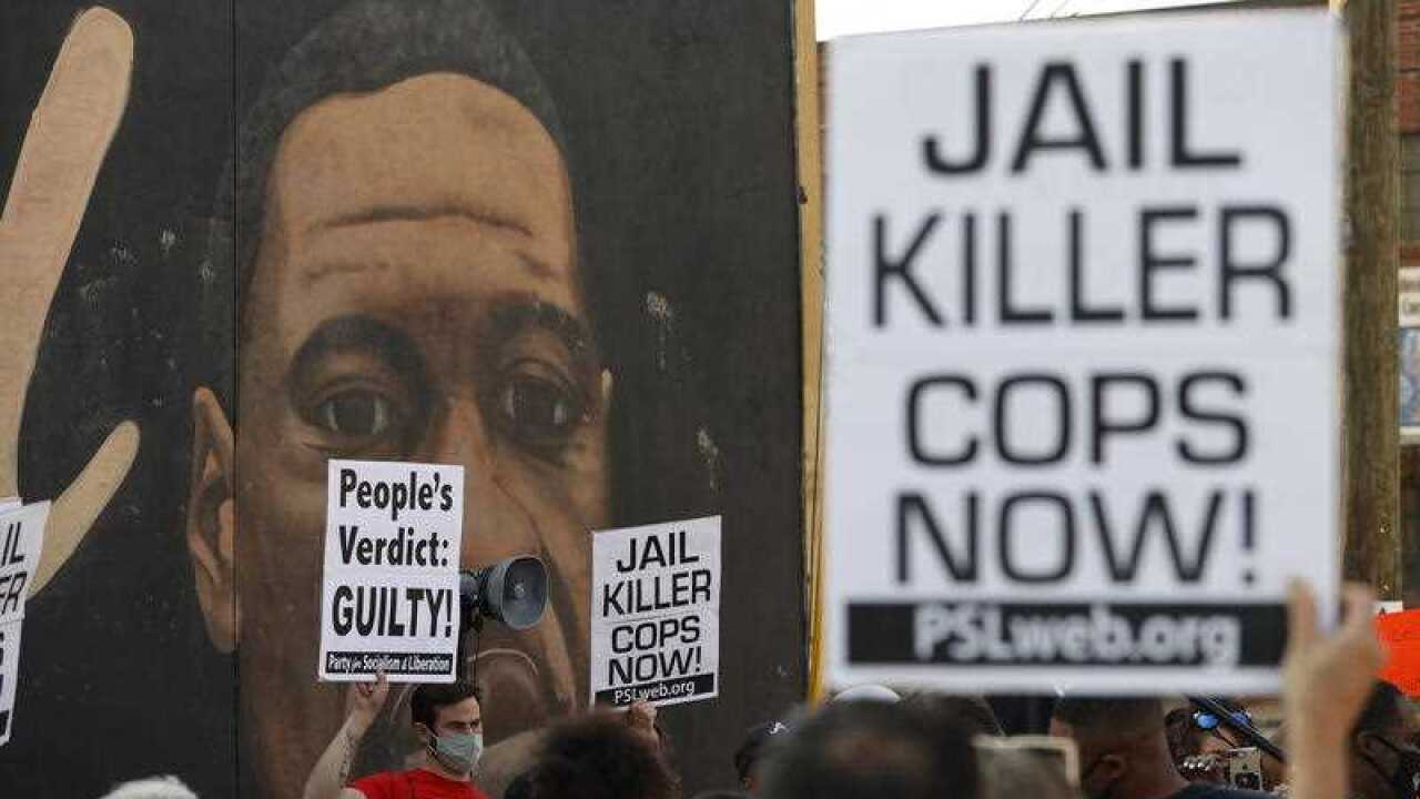 People react near a mural of George Floyd after former Minneapolis Police Department Police Officer Derek Chauvin was found guilty on all counts in Minneapolis, Minnesota in the death of Floyd in Atlanta, Georgia USA, 20 April 2021.