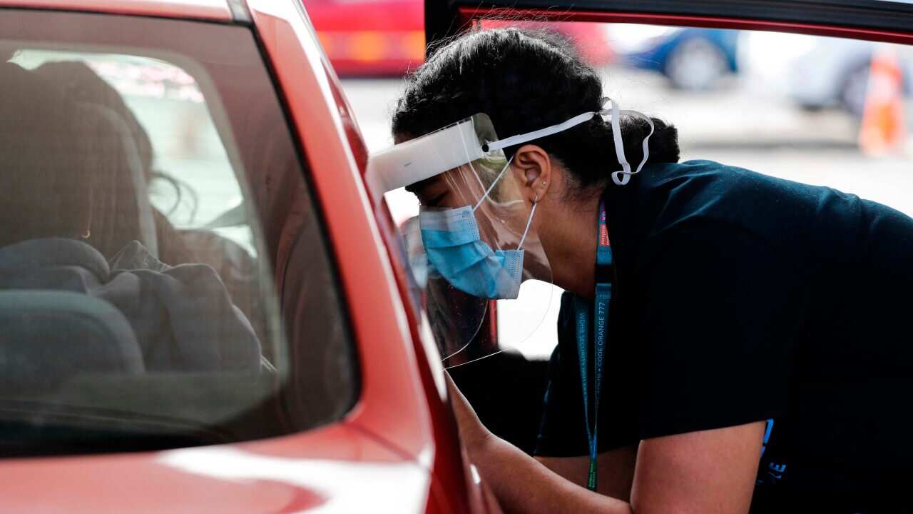 A health worker administers vaccinations at a pop-up drive-in clinic in Auckland, New Zealand.