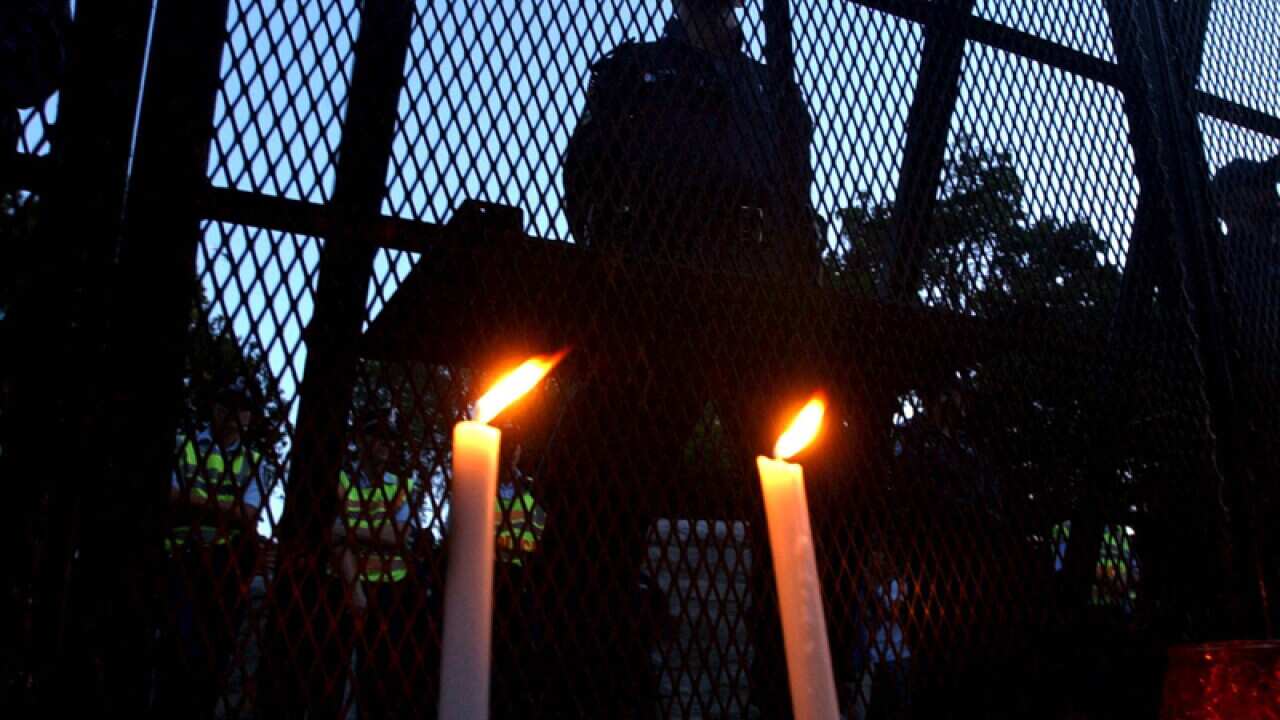 Refugee activists hold a candlelight vigil
