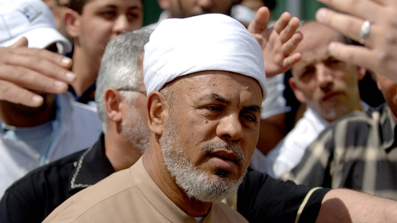 A man wearing a Muslim prayer cap.