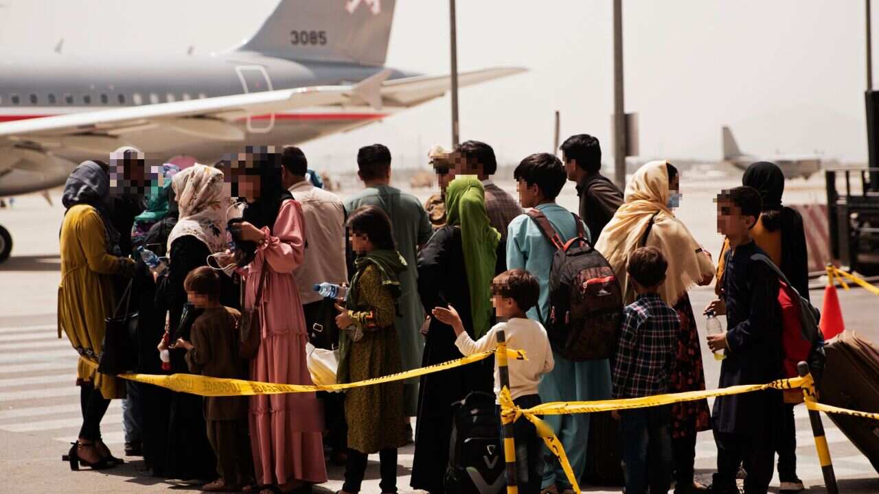 Afghans prepare to board a US plane during an evacuation at Hamid Karzai International Airport, Kabul.