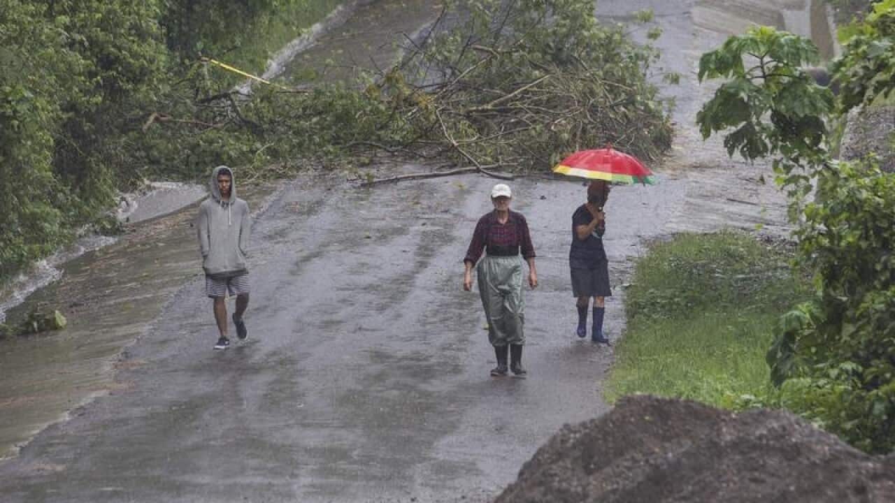 Neighbours walk under the rain