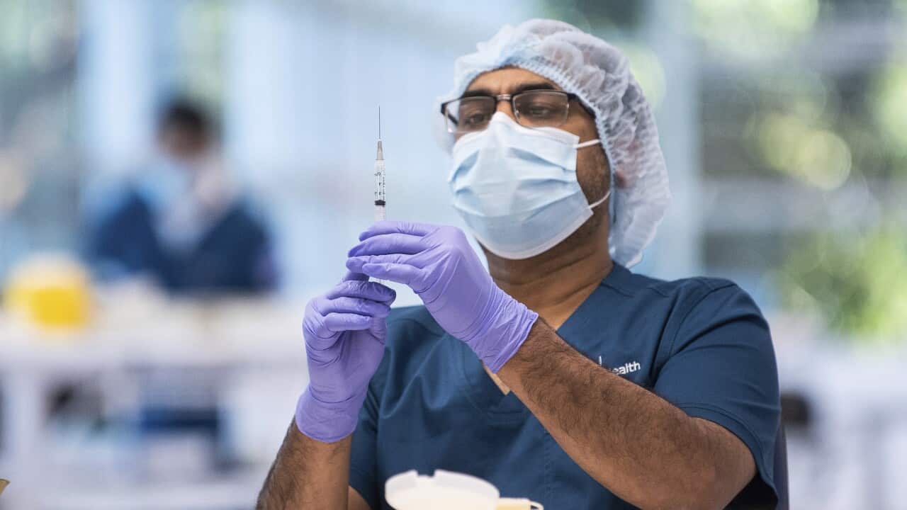 A technician prepares a vaccine in the pharmacy area of the COVID-19 Vaccination Centre in Sydney, Australia on Monday, 10 May, 2021.