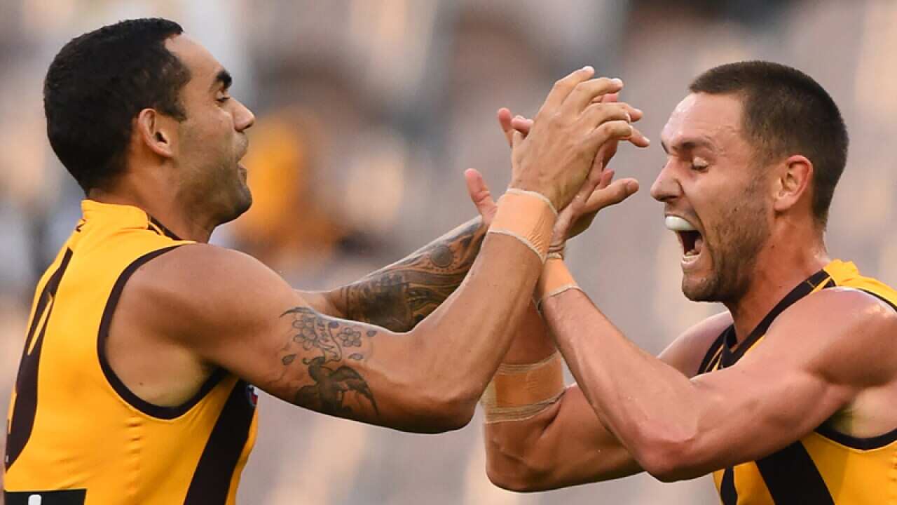 Hawthorne player Shaun Burgoyne congratulates Jack Gunston