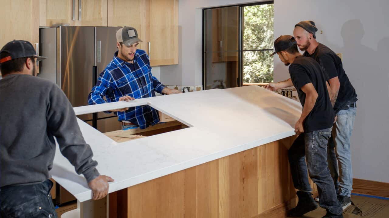 Engineered Stonel - men installing countertops
