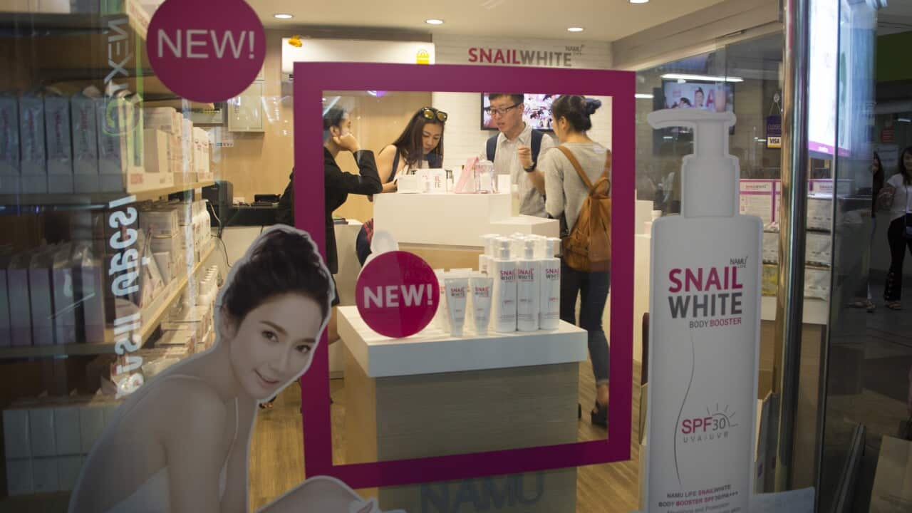 People view skin whitening products in a store in Bangkok, Thailand, 4 February 2018