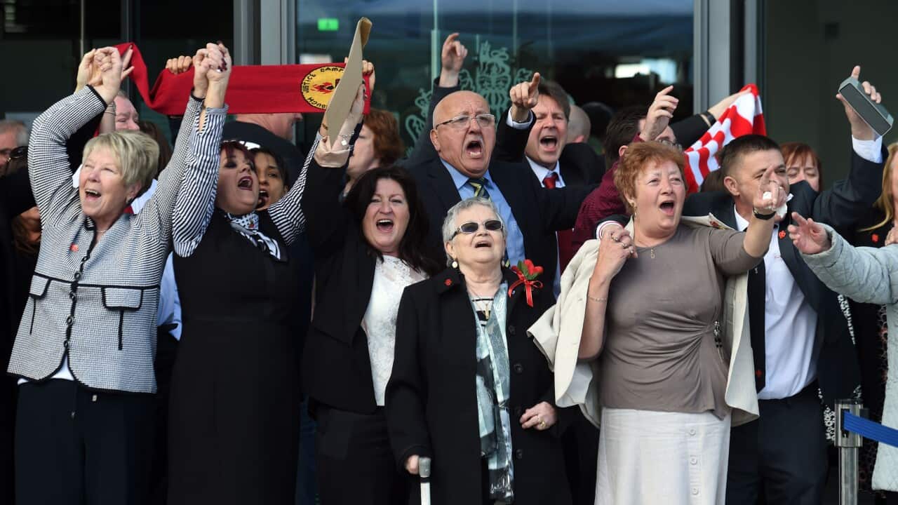 Relatives of those who died in the Hillsborough disaster sing 'You'll Never Walk Alone' outside the Hillsborough Inquest in Warrington, England