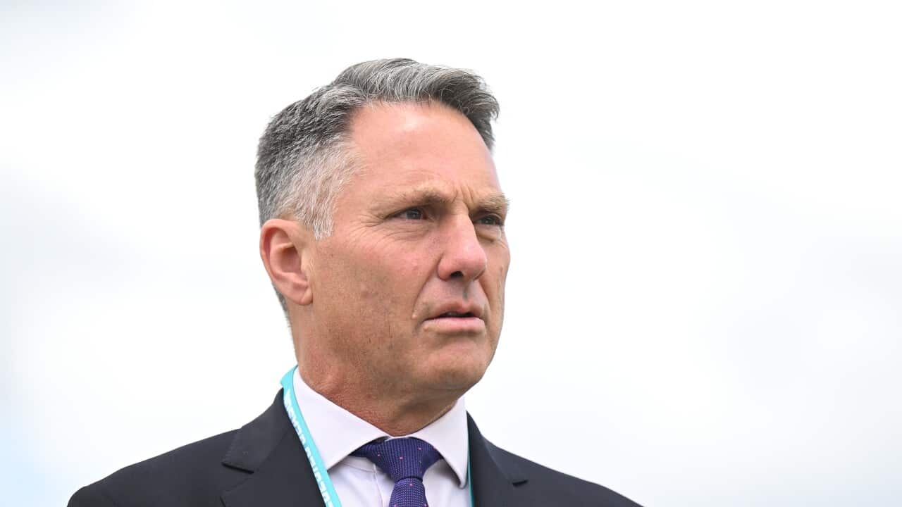 Richard Marles in a suit standing outside against a grey sky