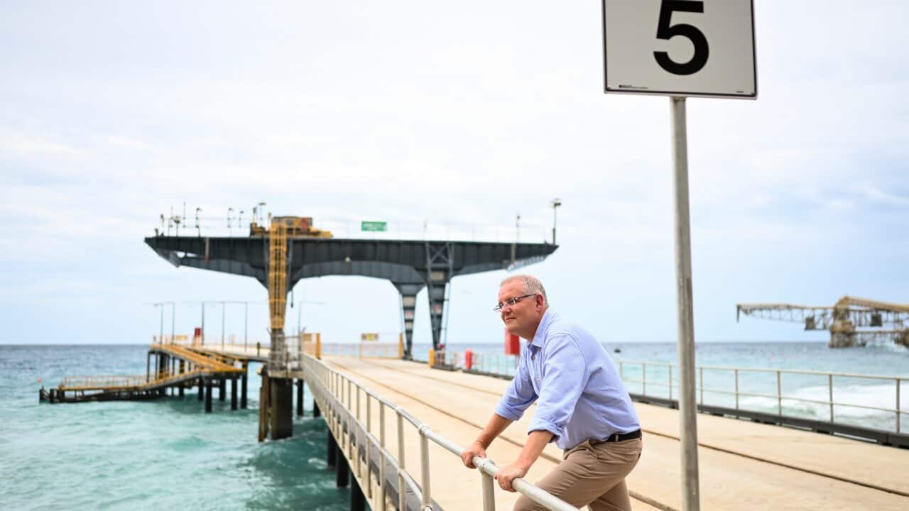 Australian Prime Minister Scott Morrison poses for photographs on the Christmas Island jetty.