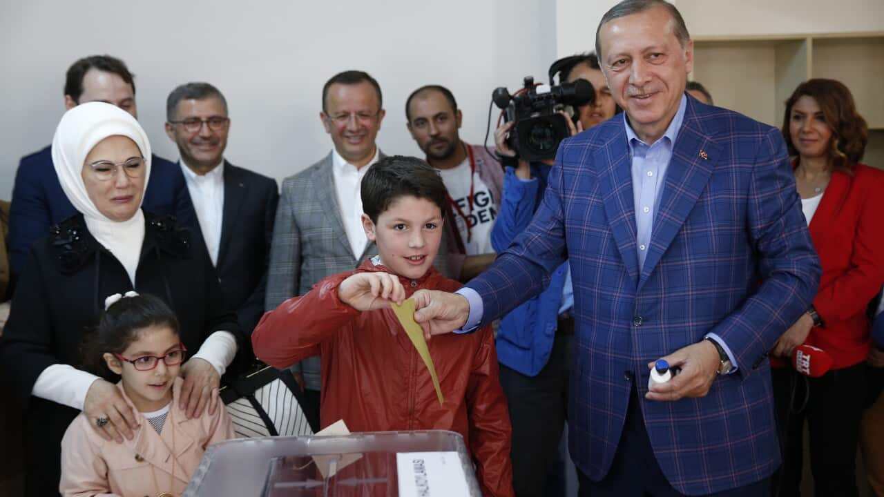 Turkey's President Recep Tayyip Erdogan casts a ballot at a polling station in Istanbul.