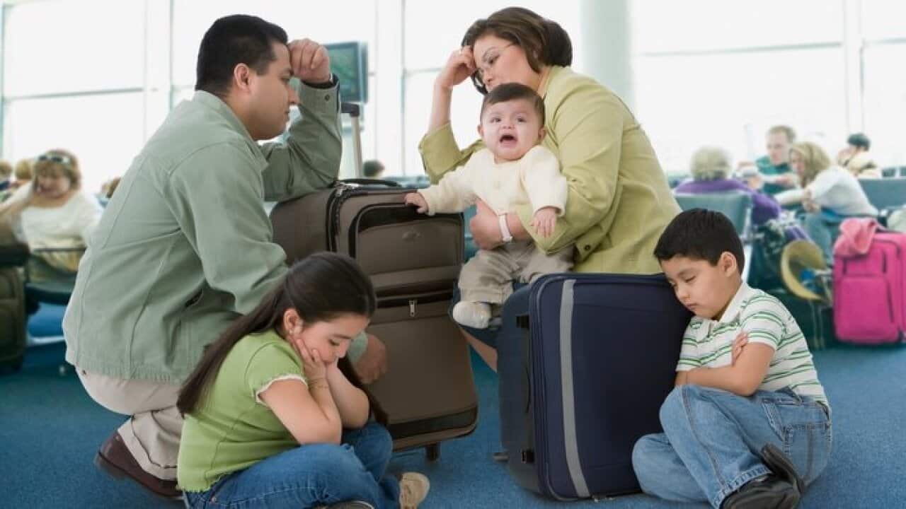 Multi-ethnic family waiting in airport