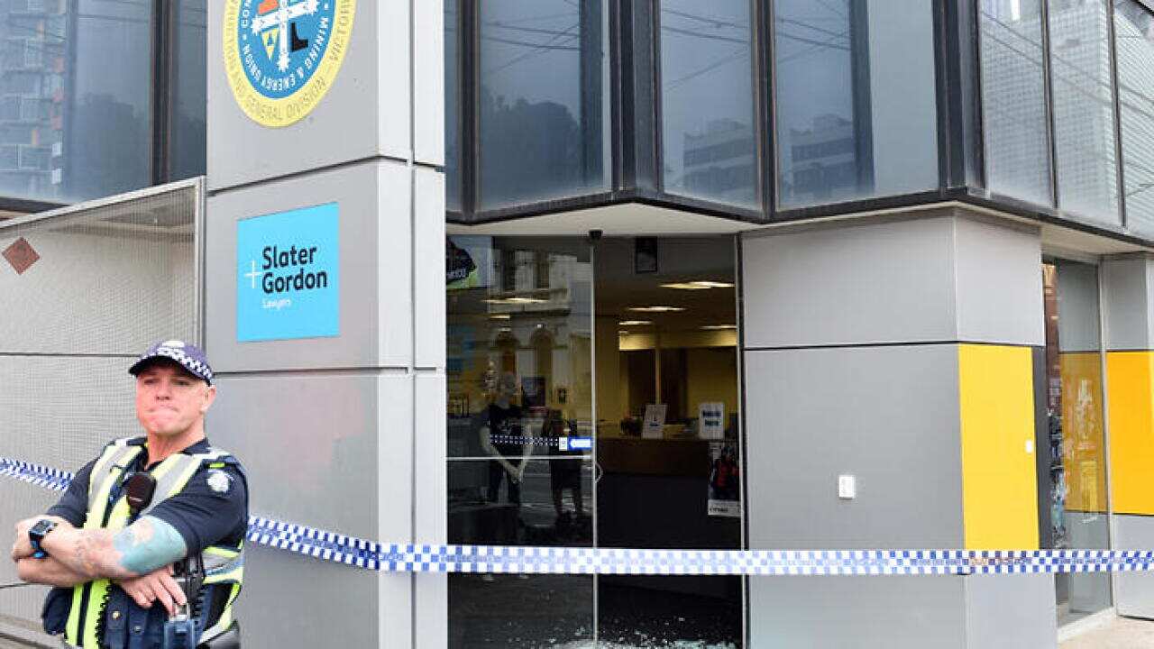 Police investigate at the CFMEU headquarters in Swanston Street after shots were fired at the building overnight in Melbourne, Wednesday, Dec. 21, 2016. (AAP Image/Julian Smith) NO ARCHIVING