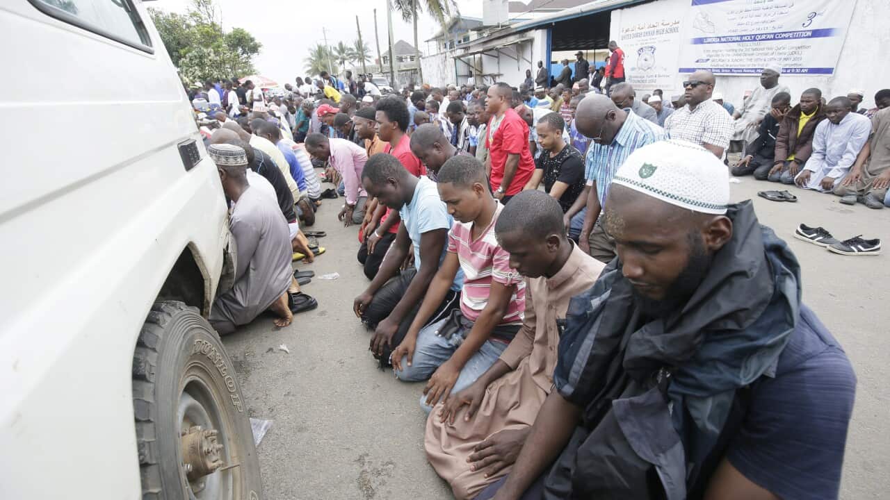 Muslims perform prayers during the funeral service for children killed in a school fire outbreak, at the 17th street Islamic Mosque, in Monrovia, Liberia.