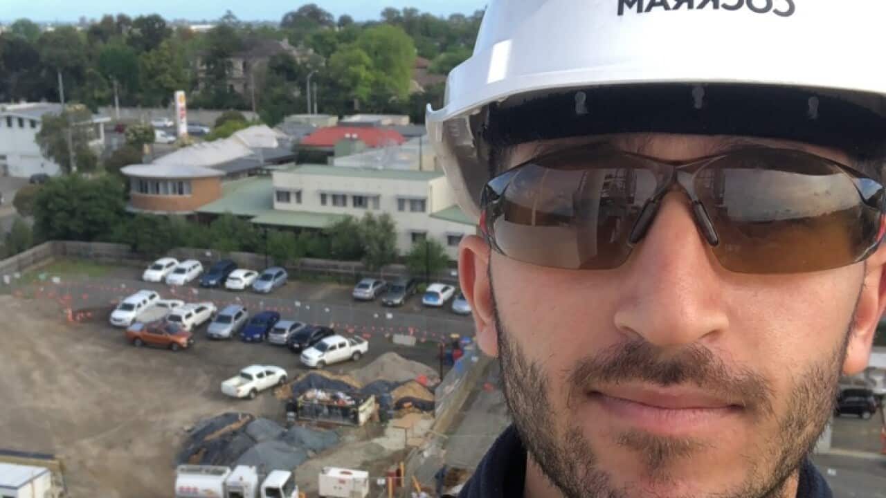 Valan Ali at the peak of a high rise construction