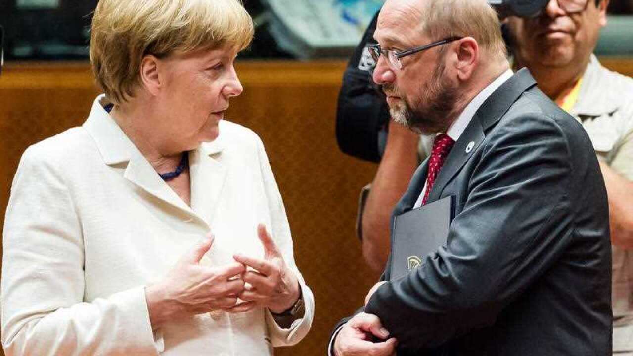 German Chancellor Angela Merkel, left, speaks with European Parliament President Martin Schultz during a meeting of eurozone heads of state at the EU Council building in Brussels