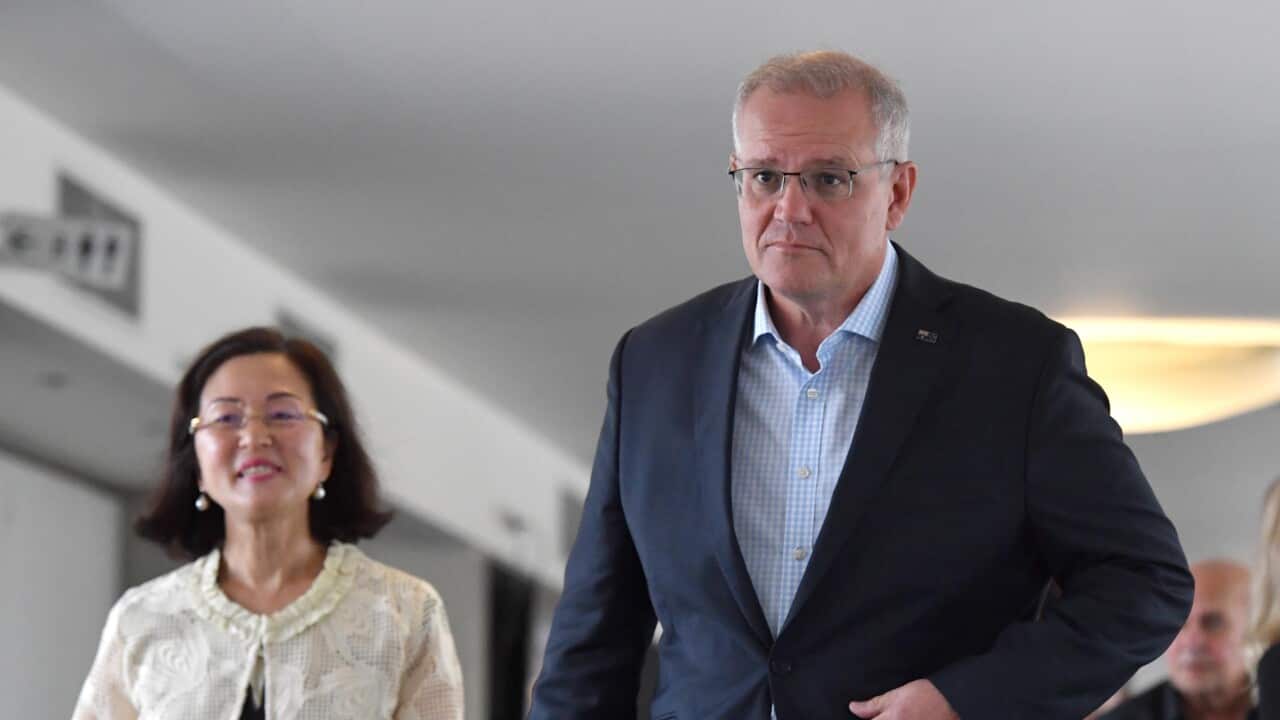 Prime minister Scott Morrison walking with MP Gladys Liu